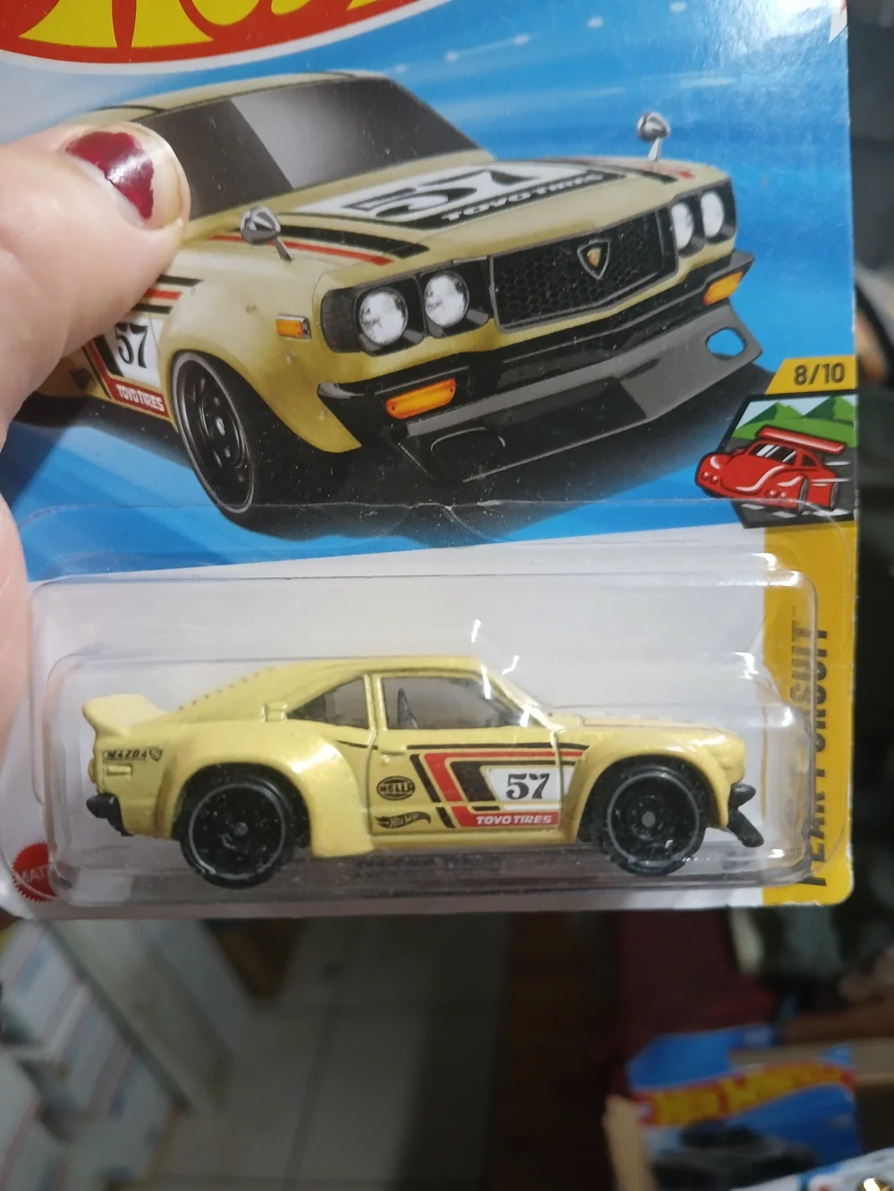 1:64 scale die-cast yellow Mazda RX-3 from the Hot Wheels Peak Pursuit series (n